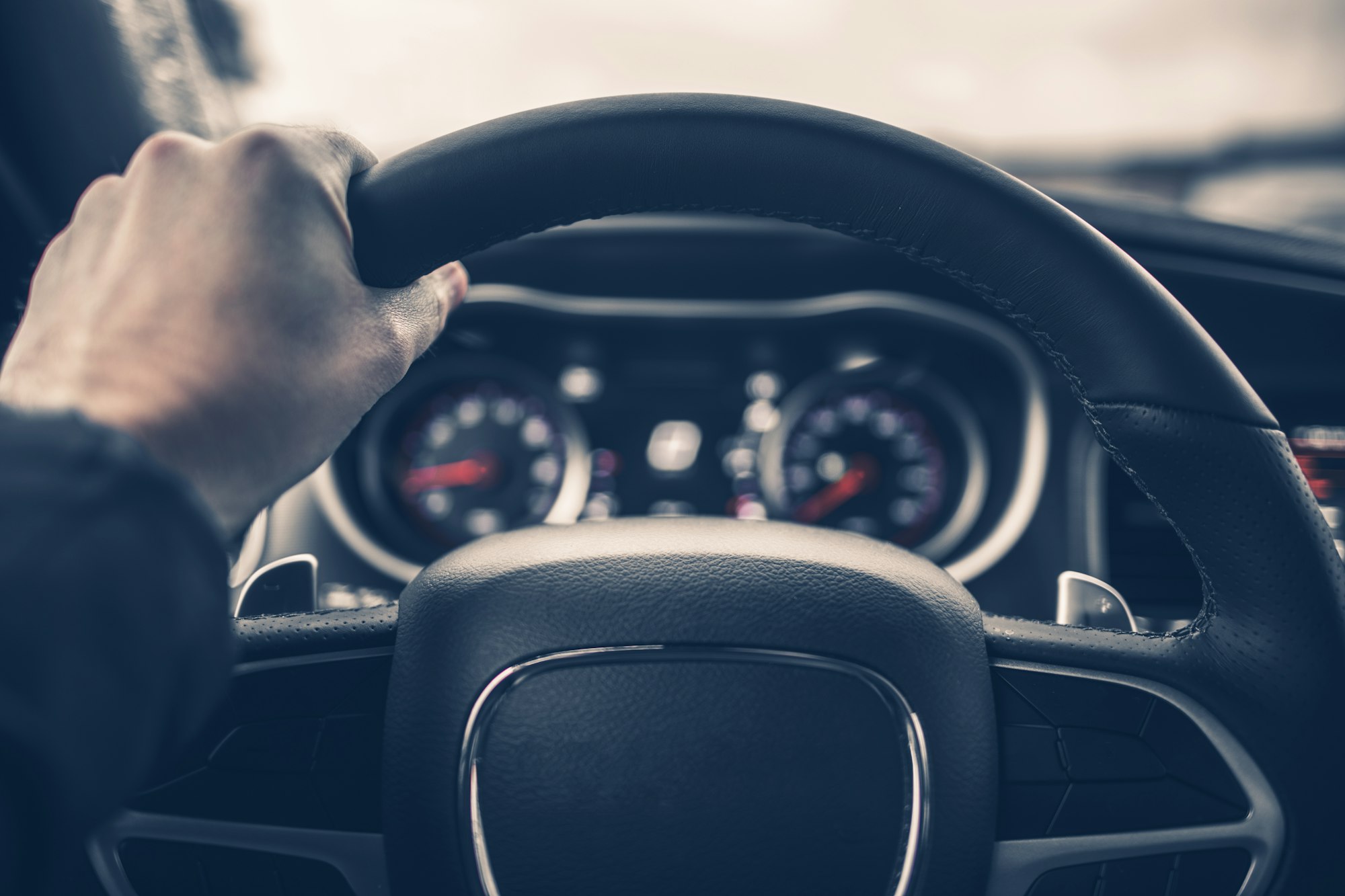 Hand on Car Steering Wheel